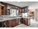 This kitchen boasts dark wood cabinetry, stainless appliances, and a large window to let in the light at 800 Glenairy Dr, Atlanta, GA 30328