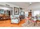 Elegant living room featuring hardwood floors, a cozy armchair, and access to the dining area, perfect for entertaining at 800 Glenairy Dr, Atlanta, GA 30328