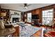 Charming living room with wood paneling, a white brick fireplace, and many large windows at 800 Glenairy Dr, Atlanta, GA 30328