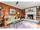 Charming living room with wood paneling, a white brick fireplace, and hardwood floors at 800 Glenairy Dr, Atlanta, GA 30328