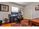 Bright home office with hardwood floors, a modern desk setup, and closet with white bi-fold doors at 800 Glenairy Dr, Atlanta, GA 30328