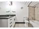 Bathroom vanity featuring a dark countertop and modern fixtures, with a shower and tub at 1261 Caroline St # 211, Atlanta, GA 30307