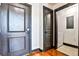 Condo entryway featuring dark-trimmed doors, warm hardwood floors, and laundry closet at 1261 Caroline St # 211, Atlanta, GA 30307