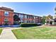 Exterior of a brick building with large windows, landscaping, and a gazebo at 1261 Caroline St # 211, Atlanta, GA 30307