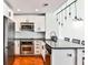 Modern kitchen features stainless steel appliances, granite countertops and wooden floors at 1261 Caroline St # 211, Atlanta, GA 30307