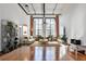 Bright living room boasts exposed brick, large windows, high ceilings and gleaming hardwood floors at 1261 Caroline St # 211, Atlanta, GA 30307