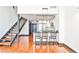 Open-concept living room featuring a kitchen island, modern lighting, and staircase at 1261 Caroline St # 211, Atlanta, GA 30307