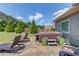 Backyard features a hot tub, stone patio, lounging chairs and manicured landscaping at 1433 Henderson Ridge Ln, Loganville, GA 30052