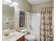 Cozy bathroom with a shower and tub, vanity, toilet and neutral decor at 1433 Henderson Ridge Ln, Loganville, GA 30052