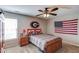 Bedroom featuring a twin bed, window, ceiling fan, carpeted floor, and sports-themed decor at 1433 Henderson Ridge Ln, Loganville, GA 30052