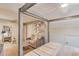 Bedroom featuring a four-poster bed, sitting area and a full-length mirror on the floor with an open closet at 1433 Henderson Ridge Ln, Loganville, GA 30052