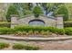 Elegant stone entrance sign for Henderson Ridge community with manicured landscaping at 1433 Henderson Ridge Ln, Loganville, GA 30052