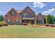 Beautiful brick home with manicured lawn and colorful landscaping in a desirable neighborhood at 1433 Henderson Ridge Ln, Loganville, GA 30052