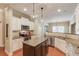 Spacious kitchen with granite countertops, a dark wood island, and stainless steel appliances at 1433 Henderson Ridge Ln, Loganville, GA 30052