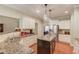 Bright kitchen with stainless steel appliances, granite countertops, and dark wood island at 1433 Henderson Ridge Ln, Loganville, GA 30052