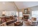 Cozy living room with a fireplace, high ceilings, and comfortable seating at 1433 Henderson Ridge Ln, Loganville, GA 30052