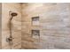 Stylish tiled shower featuring a rainfall showerhead and built-in shelving at 1433 Henderson Ridge Ln, Loganville, GA 30052