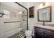 Modern bathroom with a glass-enclosed shower featuring decorative tiling and a dark vanity with granite countertop at 2003 Queen Anne Ct, Sandy Springs, GA 30350