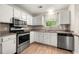 Well-equipped kitchen with stainless steel appliances and ample cabinet space at 2003 Queen Anne Ct, Sandy Springs, GA 30350