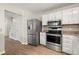 Modern kitchen with stainless steel appliances and adjacent dining area at 2003 Queen Anne Ct, Sandy Springs, GA 30350