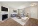 Bright living room with a cozy fireplace, plush seating, and modern decor at 2003 Queen Anne Ct, Sandy Springs, GA 30350
