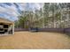 Spacious fenced backyard with a covered patio and a view of the surrounding trees at 117 Jacobs Ln, Loganville, GA 30052