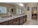 Bathroom with dual sinks, granite countertops, and a glass-enclosed shower for a luxurious experience at 117 Jacobs Ln, Loganville, GA 30052