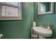 Cozy powder room with pedestal sink and decorative wall color offers comfort and convenience at 117 Jacobs Ln, Loganville, GA 30052