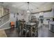 Dining area with hardwood floors, staircase access, adjacent kitchen with stainless steel appliances at 117 Jacobs Ln, Loganville, GA 30052