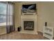 Cozy fireplace with mantel, decorative candles, and a large window with natural light at 117 Jacobs Ln, Loganville, GA 30052
