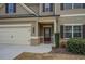 Inviting front porch with craftsman door and a spacious two-car garage at 117 Jacobs Ln, Loganville, GA 30052