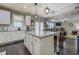 Bright kitchen with granite island, hardwood floors, stainless appliances, and seamless access to dining at 117 Jacobs Ln, Loganville, GA 30052
