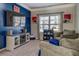 Comfortable living room with a large TV, electric fireplace, plush seating, and a bright window for natural light at 117 Jacobs Ln, Loganville, GA 30052