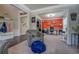 Open-concept living space with a cozy chair, view of the entryway and a bright office with built in shelves at 117 Jacobs Ln, Loganville, GA 30052