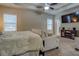 Well-lit main bedroom featuring a trey ceiling, ceiling fan and sitting area for relaxation at 117 Jacobs Ln, Loganville, GA 30052