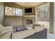 Relaxing covered patio with cozy seating, an outdoor fireplace, and a mounted TV for comfortable outdoor entertaining at 117 Jacobs Ln, Loganville, GA 30052
