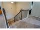 Carpeted staircase with wood and iron railing leads to the upper level of the home at 117 Jacobs Ln, Loganville, GA 30052