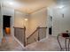 Carpeted staircase featuring a dark railing at 117 Jacobs Ln, Loganville, GA 30052