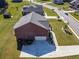 An aerial view of a well-maintained house with a driveway, a garage, and a manicured lawn at 1468 Harlequin Way, Stockbridge, GA 30281