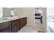 Bathroom featuring double vanity and tile flooring, with primary bedroom in background at 1468 Harlequin Way, Stockbridge, GA 30281