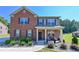 Traditional two-story brick home with a covered front porch and landscaped yard at 1468 Harlequin Way, Stockbridge, GA 30281