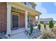 Inviting front porch with rocking chairs, brick facade, and manicured shrubbery at 1468 Harlequin Way, Stockbridge, GA 30281