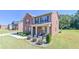 Traditional two-story brick home boasting manicured landscaping and an inviting front porch area at 1468 Harlequin Way, Stockbridge, GA 30281