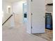 Upstairs hallway with carpet flooring and open doors at 1468 Harlequin Way, Stockbridge, GA 30281