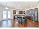 Bright kitchen with stainless steel appliances, granite countertops and hardwood floors at 1468 Harlequin Way, Stockbridge, GA 30281