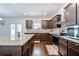 Stylish kitchen featuring granite countertops, stainless steel appliances, and dark wood cabinetry at 1468 Harlequin Way, Stockbridge, GA 30281