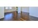 Open living space with dark hardwood flooring and light colored walls at 1468 Harlequin Way, Stockbridge, GA 30281