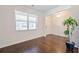 Hardwood floors and bright natural light fill this cozy living room with plant at 1468 Harlequin Way, Stockbridge, GA 30281
