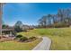 Expansive backyard featuring lush greenery, a wooden deck, and mature trees at 403 Tea Olive Ct, Canton, GA 30115