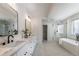 Luxurious bathroom with a soaking tub, glass shower, and double sinks at 403 Tea Olive Ct, Canton, GA 30115